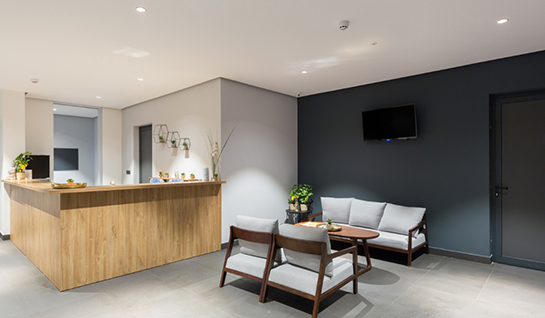 Front desk, couch, and table in dental waiting room