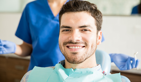 Man sitting in dental chair smiling