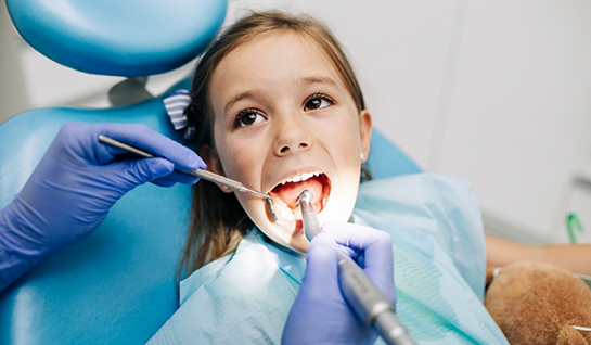 Little girl having teeth examined by children's dentist in Riverdale Park