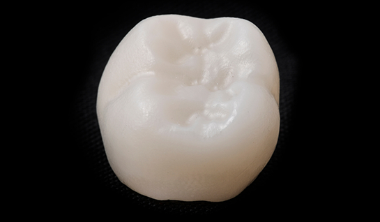 Lifelike dental crown on a black background