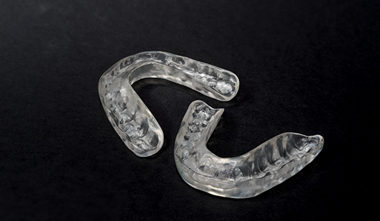 Two aligners on black surface