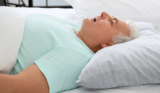 Man with sleep apnea in Riverdale Park sleeping on his back and snoring